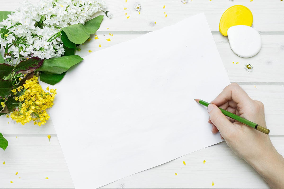 Image of hand starting to write in journal