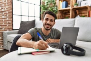 Man journaling at computer